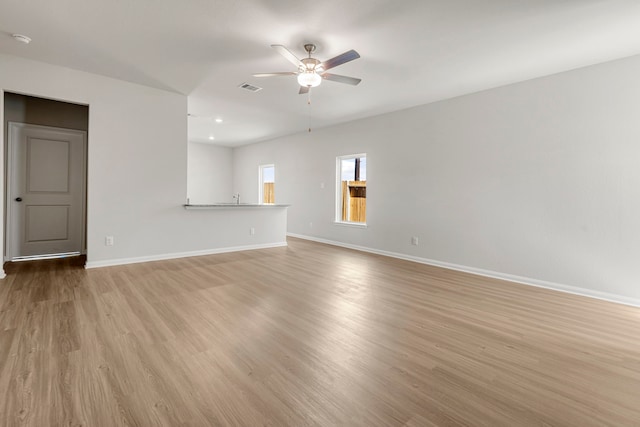 unfurnished living room featuring light hardwood / wood-style flooring and ceiling fan