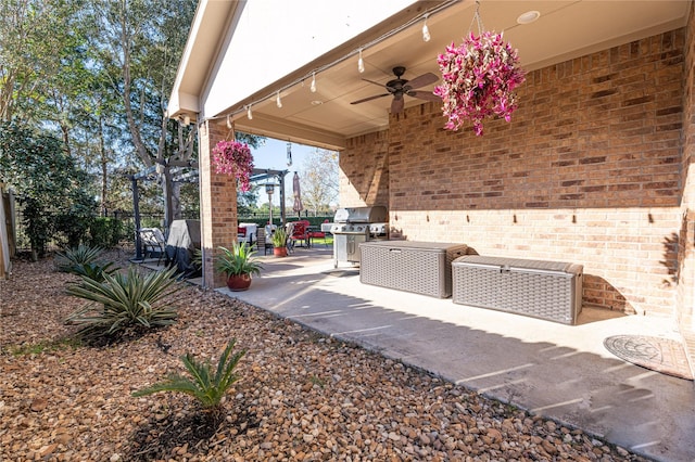 view of patio featuring area for grilling and ceiling fan