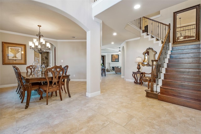 dining space with crown molding and ceiling fan with notable chandelier