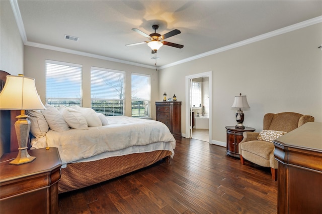 bedroom featuring connected bathroom, dark wood-type flooring, ceiling fan, and crown molding