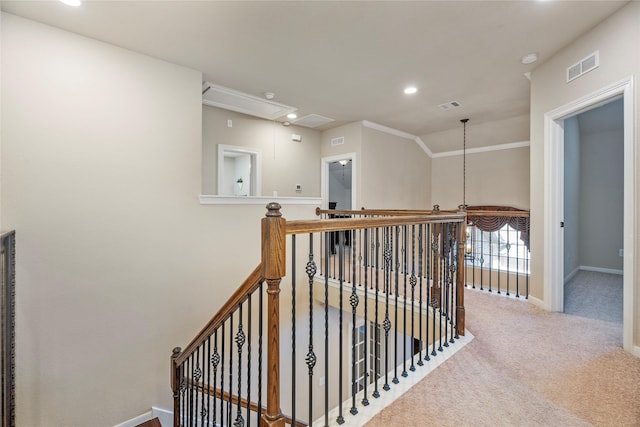 hallway with carpet flooring, vaulted ceiling, and ornamental molding