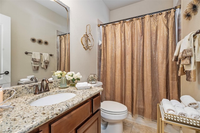 bathroom featuring tile patterned floors, vanity, and toilet