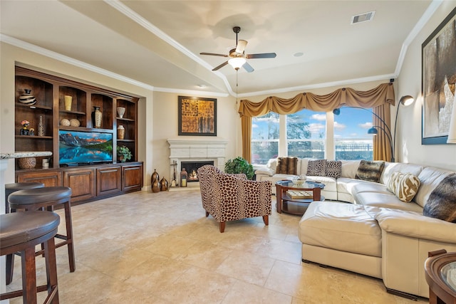 living room with ceiling fan and ornamental molding