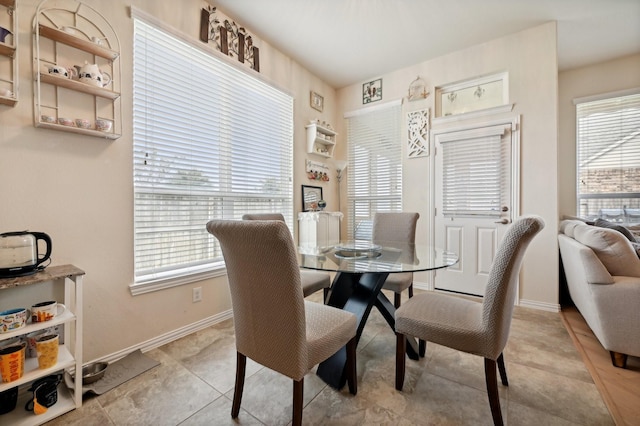 dining space with plenty of natural light and light tile patterned floors