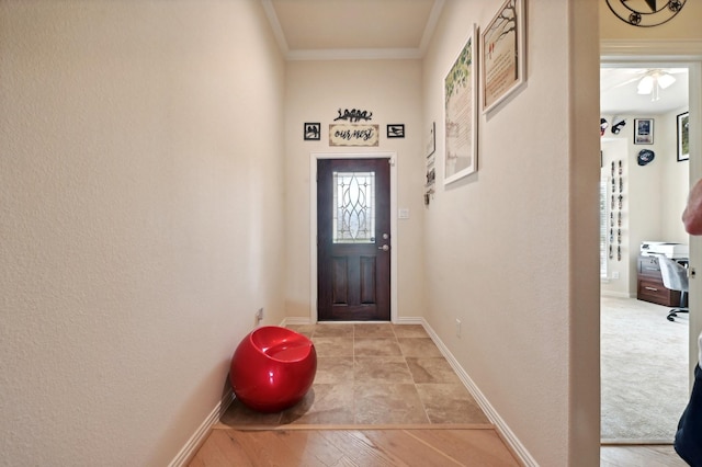 doorway to outside with light hardwood / wood-style floors, ceiling fan, and crown molding