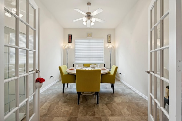 dining space with ceiling fan and french doors