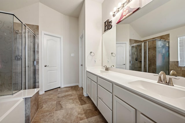 bathroom with vanity, vaulted ceiling, and walk in shower