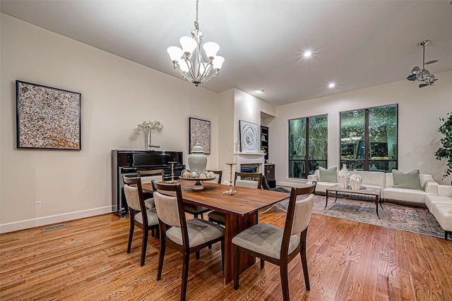 dining room with a chandelier and light hardwood / wood-style floors