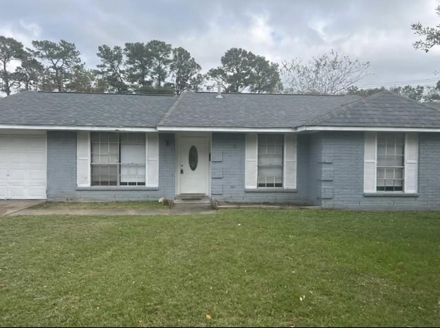 single story home with a front yard and a garage