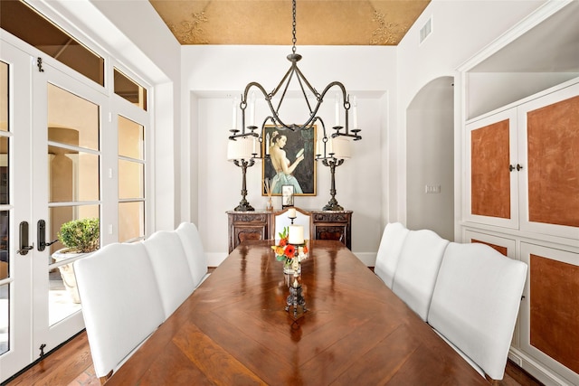 dining room with french doors and hardwood / wood-style flooring