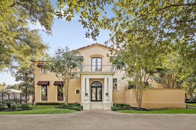 mediterranean / spanish-style house with french doors and a balcony