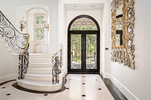 tiled entrance foyer featuring french doors