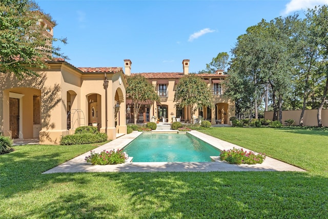 view of pool with a yard