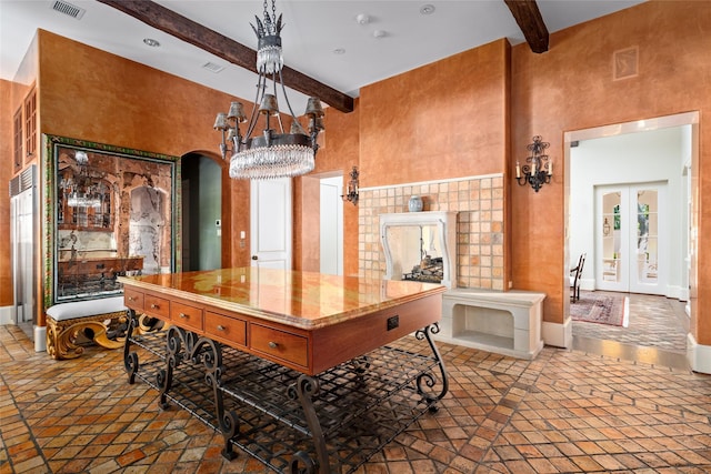 interior space featuring beamed ceiling, french doors, and a towering ceiling