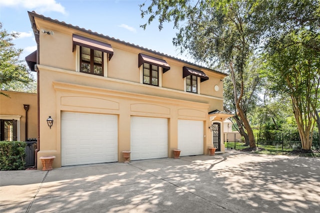 mediterranean / spanish-style home with a garage