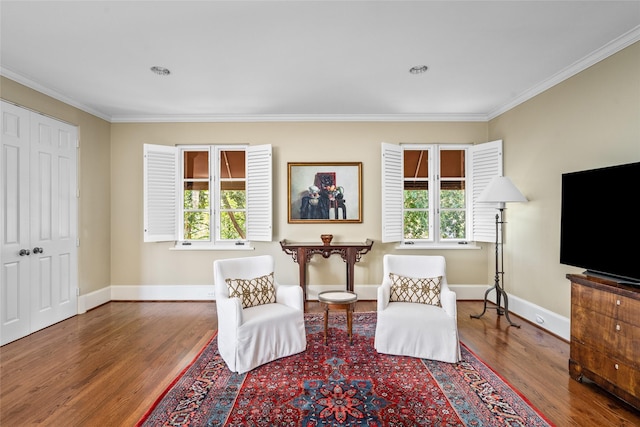 sitting room featuring hardwood / wood-style floors and crown molding