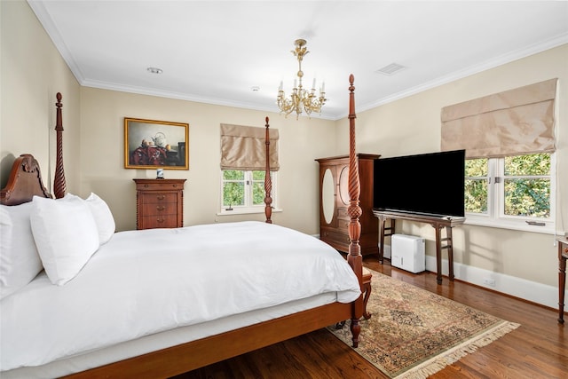 bedroom featuring a chandelier, hardwood / wood-style flooring, and crown molding