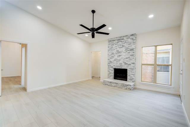 unfurnished living room with a fireplace, light wood-type flooring, and ceiling fan