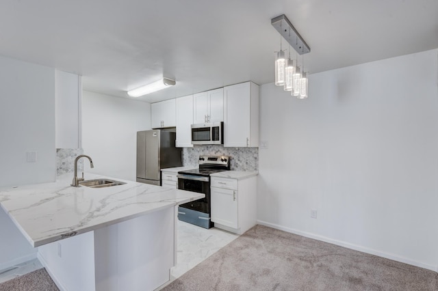 kitchen with kitchen peninsula, stainless steel appliances, light colored carpet, sink, and white cabinets