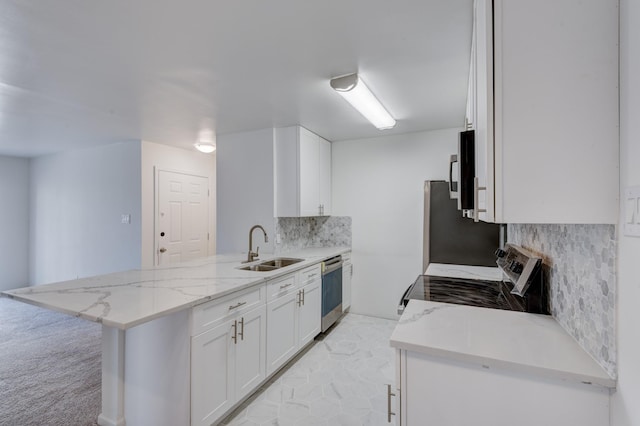 kitchen with range, white cabinets, stainless steel dishwasher, light stone counters, and kitchen peninsula