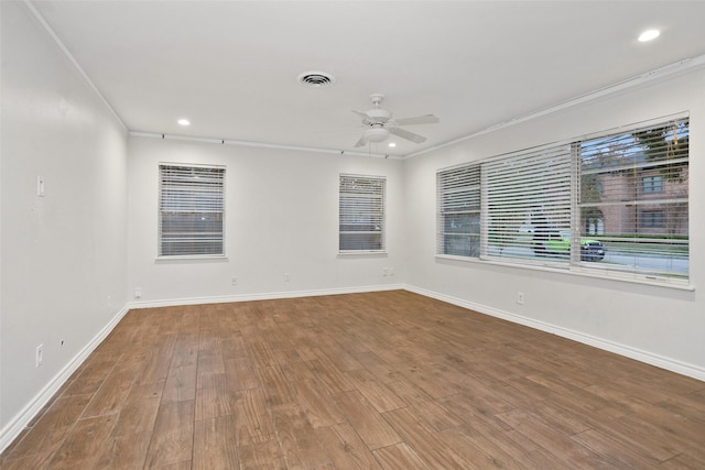 spare room featuring wood-type flooring, ceiling fan, and crown molding