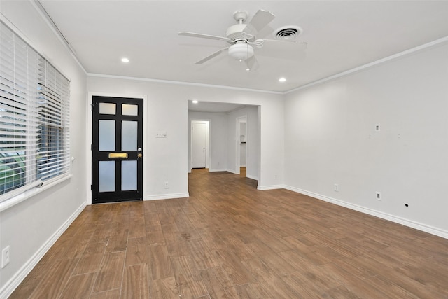 unfurnished room featuring hardwood / wood-style floors, ceiling fan, and crown molding