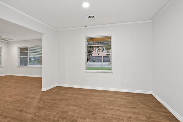 unfurnished room with hardwood / wood-style flooring, ceiling fan, and ornamental molding