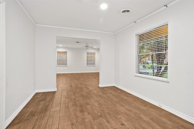 spare room with hardwood / wood-style flooring, ceiling fan, and ornamental molding