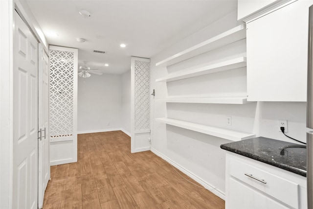 walk in closet with ceiling fan and light hardwood / wood-style floors