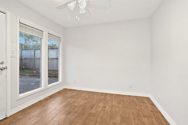 unfurnished room featuring light wood-type flooring, ceiling fan, and a healthy amount of sunlight