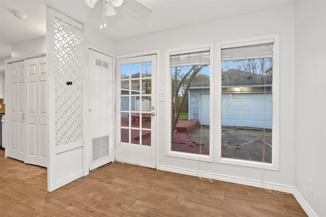 entryway with ceiling fan and wood-type flooring