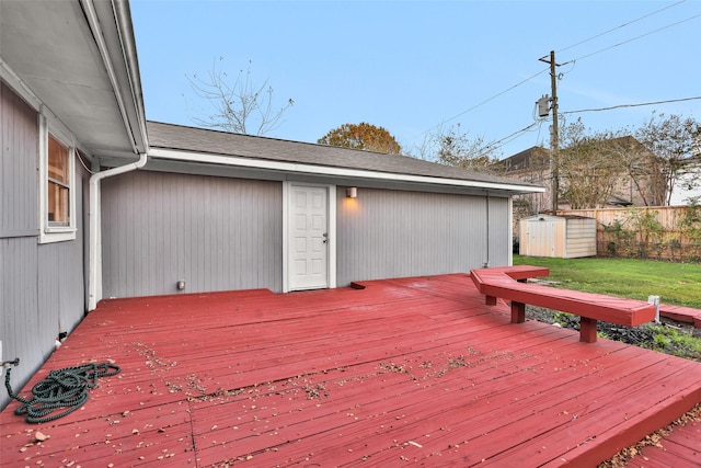 wooden terrace with a shed and a lawn