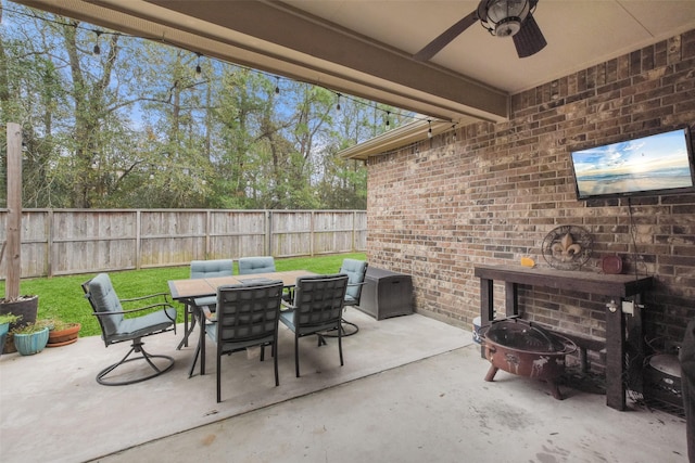 view of patio / terrace with ceiling fan and an outdoor fire pit