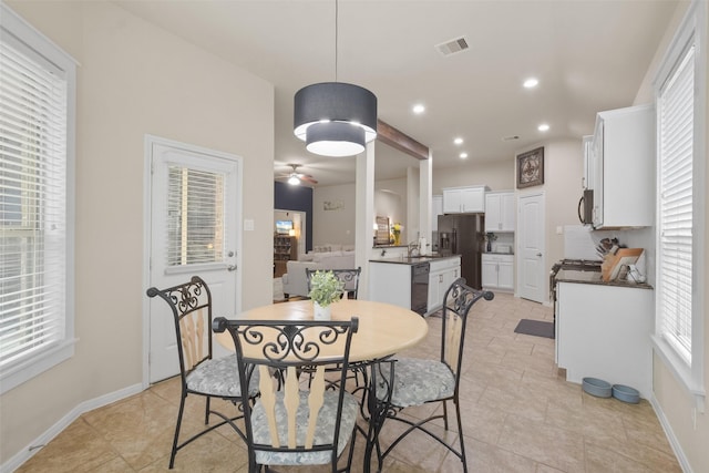 dining area featuring ceiling fan and light tile patterned floors