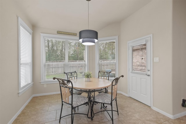 dining space with plenty of natural light, light tile patterned floors, and vaulted ceiling