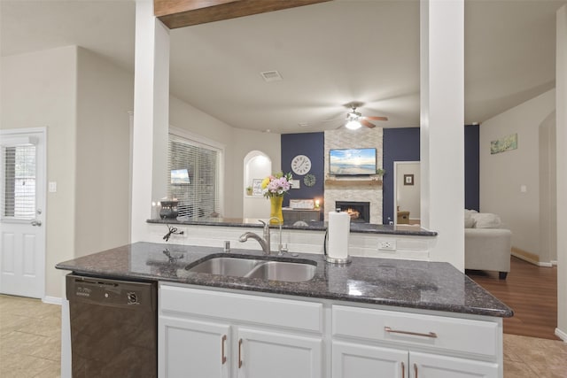 kitchen with dishwasher, white cabinetry, sink, and dark stone counters