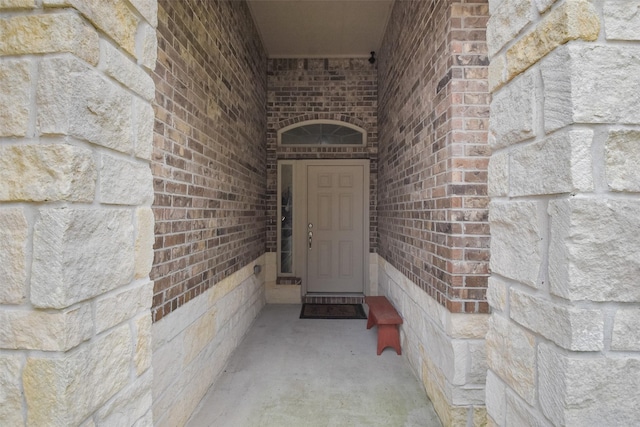 property entrance featuring brick siding