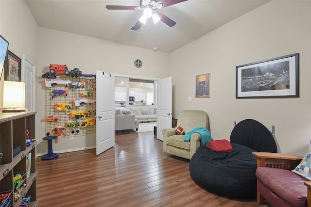 living area featuring dark hardwood / wood-style floors and ceiling fan