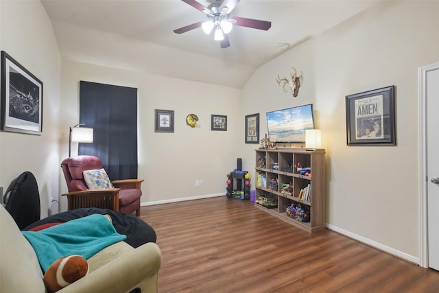 living area featuring ceiling fan, dark hardwood / wood-style flooring, and vaulted ceiling