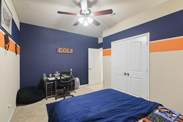 bedroom with ceiling fan, a closet, and light colored carpet