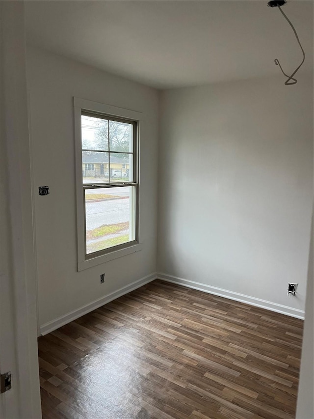 spare room with dark wood-type flooring