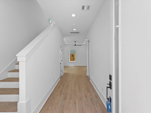 corridor with light hardwood / wood-style flooring