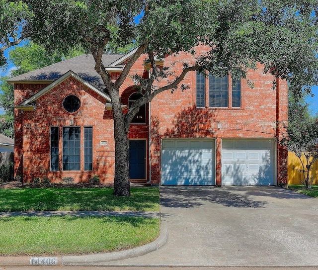 view of front of property featuring a garage and a front yard