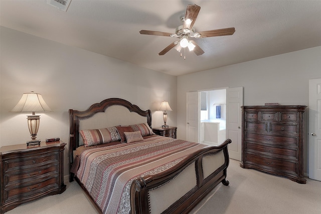 bedroom featuring ceiling fan, ensuite bathroom, and light carpet