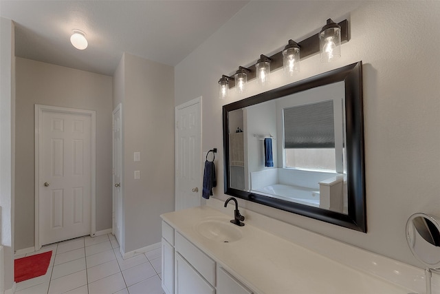 bathroom with a tub, tile patterned floors, and vanity