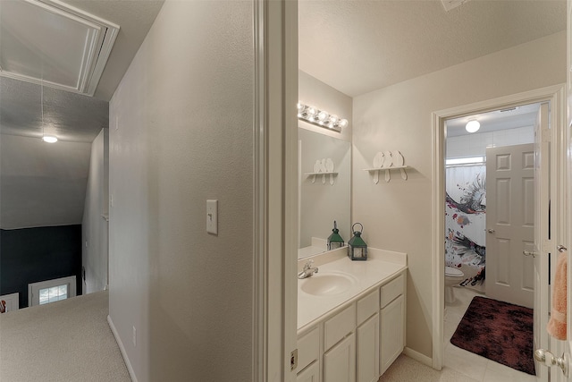 bathroom featuring a textured ceiling, toilet, vanity, and a shower with curtain