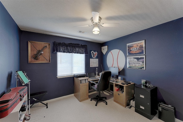 carpeted office featuring a textured ceiling and ceiling fan