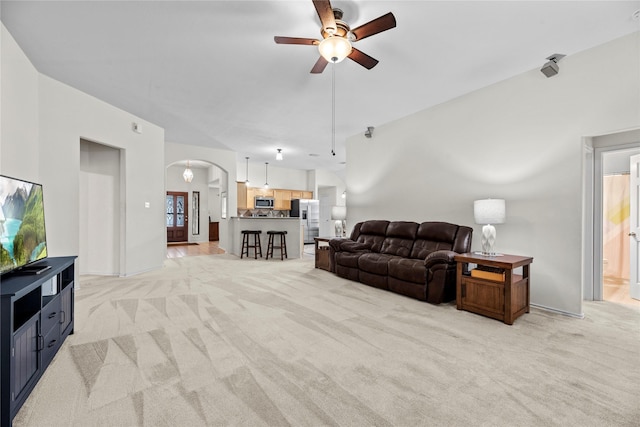 carpeted living room with ceiling fan