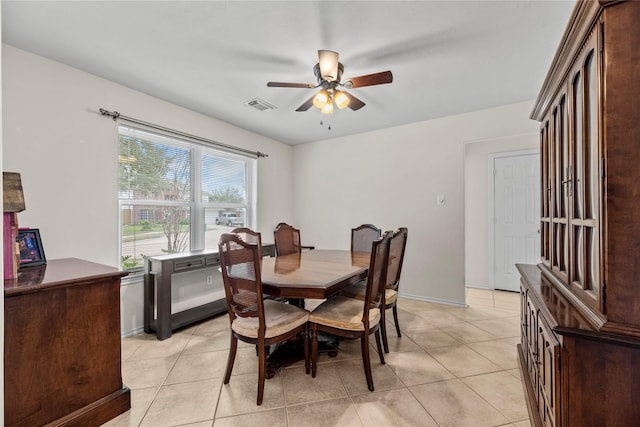 tiled dining space with ceiling fan