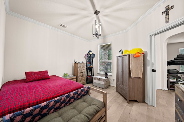 bedroom featuring light hardwood / wood-style floors and ornamental molding